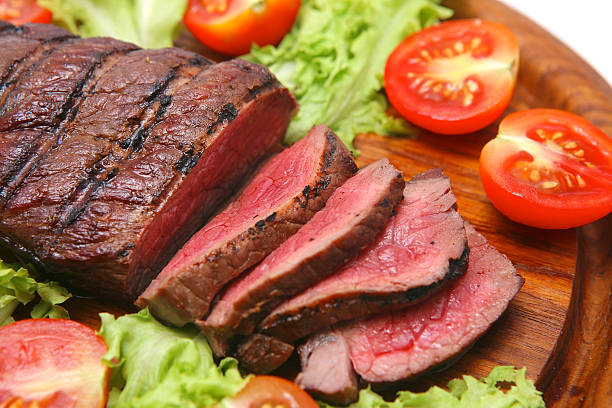 istock Grilled cut red meat surrounded by tomatoes and lettuce 92163699