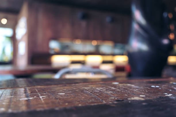 istock Vintage wooden table with blur bokeh background on cafe 921638646