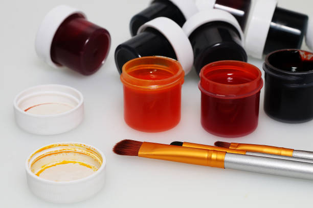 Brushes, palette and a set of paints on a white background