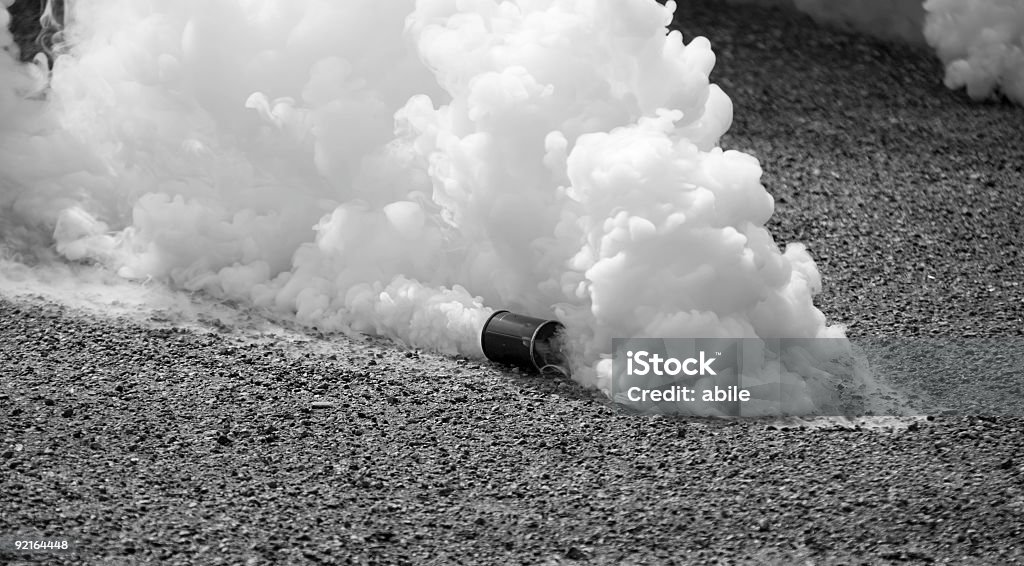 Tear gas in motion in black and white  Tear bomb in the street Tear Gas Stock Photo