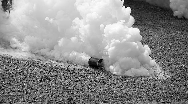 Tear gas in motion in black and white  Tear bomb in the street biological warfare stock pictures, royalty-free photos & images