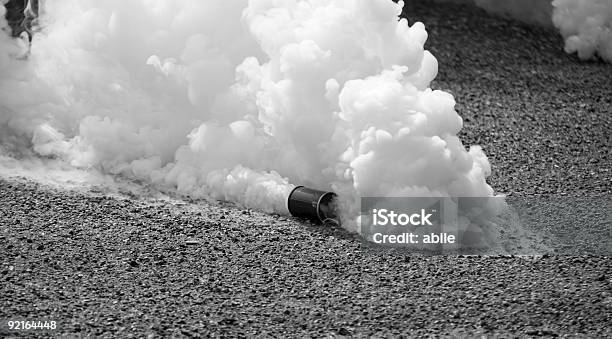 Tear Gas In Motion In Black And White Stock Photo - Download Image Now - Tear Gas, Biochemical Weapon, Riot