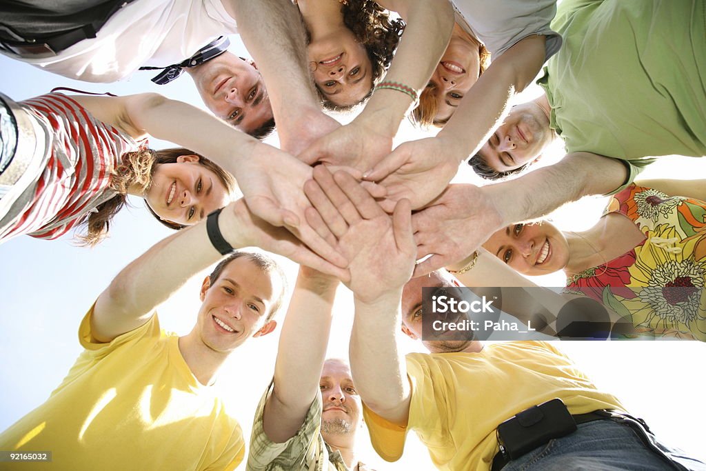 People with their hands on top of each other's hands people hands sky Circle Stock Photo