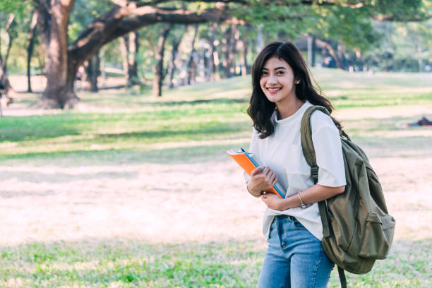 istock Woman students holding notebooks outdoors.Education concept 921653826