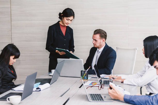 istock Businesspeople presenting and using laptops and discussing together in meeting room.Teamwork concept 921653846