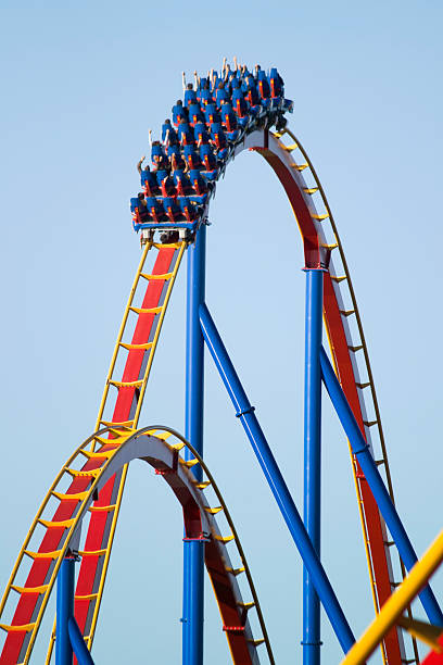 Roller Coaster Colorful roller coaster lit by low sunset to accentuate saturation. rollercoaster stock pictures, royalty-free photos & images
