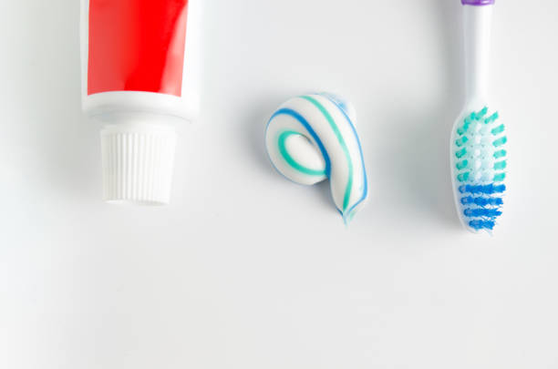 istock A tube of toothpaste and a toothbrush on white background 921654748