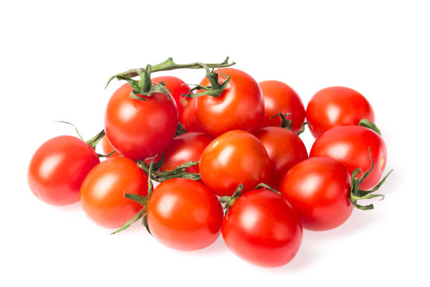 istock Fresh juicy red cherry tomato bunch closeup isolated on white background. 921661048