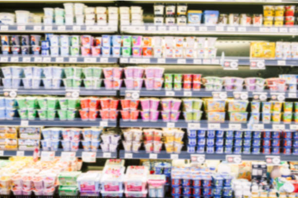 Defocused blur of yogurt on shelves in a supermarket stock photo