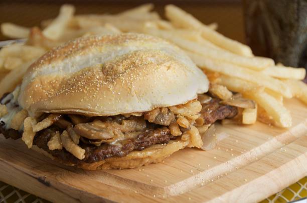 istock A burger and fries on a wooden board 92166712