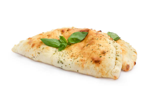 zwei warme calzone mit basilikum zweige auf weißem hintergrund - pizza pastry crust oven meat stock-fotos und bilder