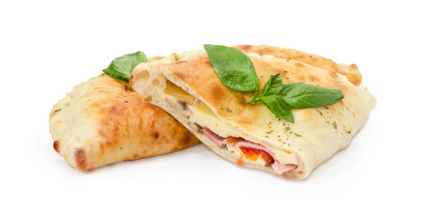 istock One whole and half of baked calzone with basil twigs 921667260