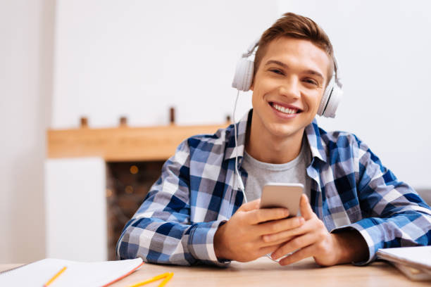 istock Joyful nice boy listening to music 921667390
