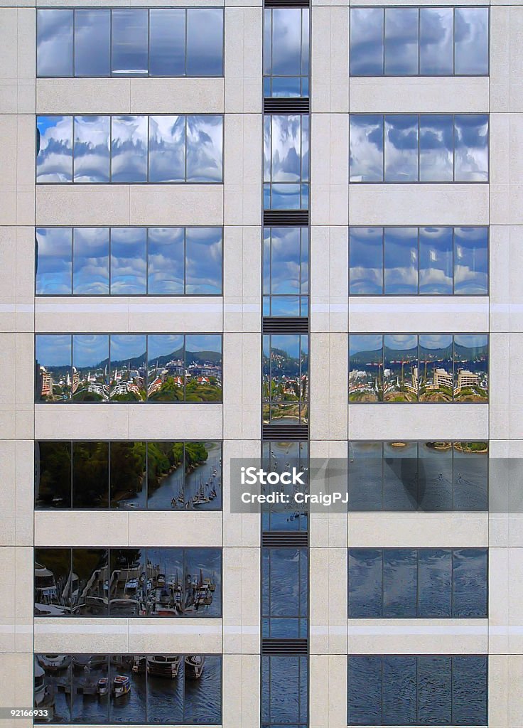River Scene Reflected in a Skyscraper The Brisbane river, riverside scenery and the cloudy sky reflected in one of the buildings on the river bank Architecture Stock Photo