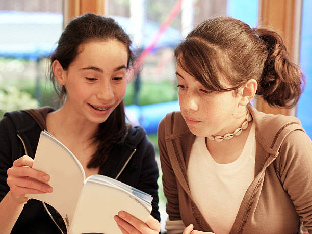 istock Teenage girls reading a book 92167280