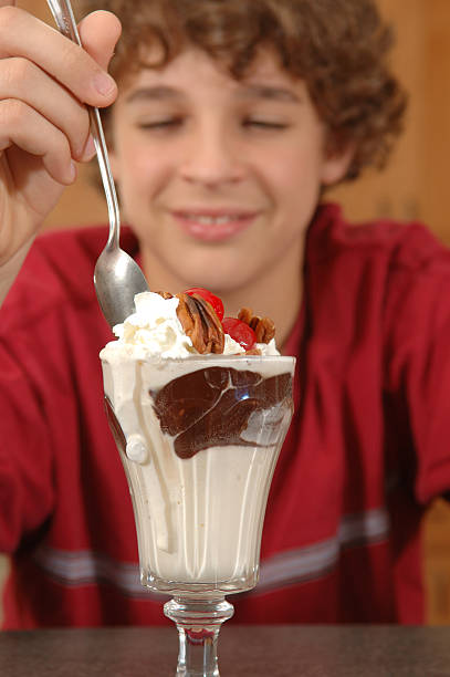 istock boy with hot fudge sundae 92167326