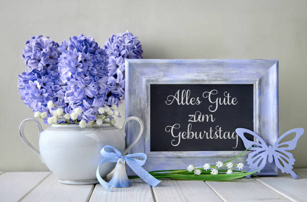 Blue decorations and hyacinth flowers on white table, blackboard with text. Springtime \