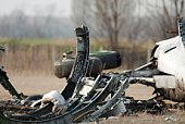 Plane wreckage and metal scraps in a field