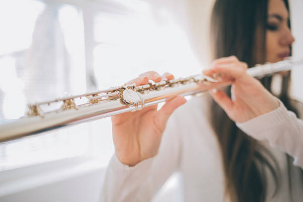 istock Young woman playing the flute. 921677326