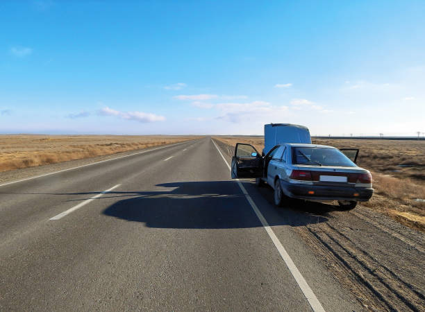 Man repairing a broken car by the road. Beyneu - Atyrau Road. Kazakhstan.