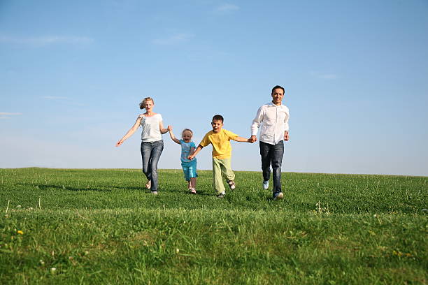 istock family of four running grass sky 92167922