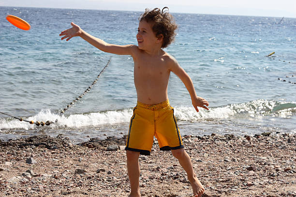 istock The boy on a beach start frisbee 92168072