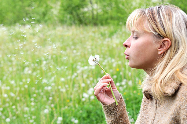 istock Girl blows on dandelion and thinks desire 2 92168085