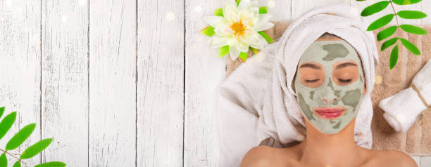 istock Young healthy woman with face clay mask 921681314