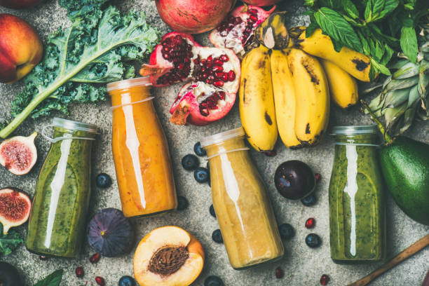 istock Colorful smoothies in bottles with fresh tropical fruit and vegetables 921681574