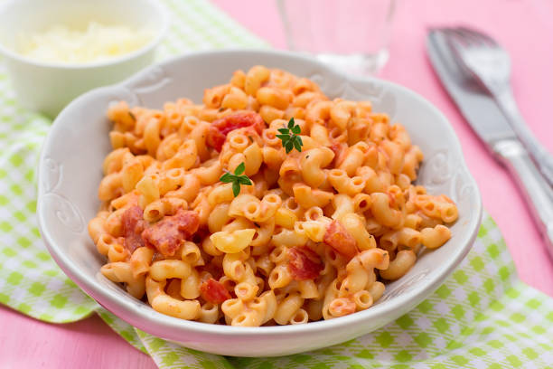 istock Pasta macaronis coquillettes with tomato and processed cheese sauce 921681770
