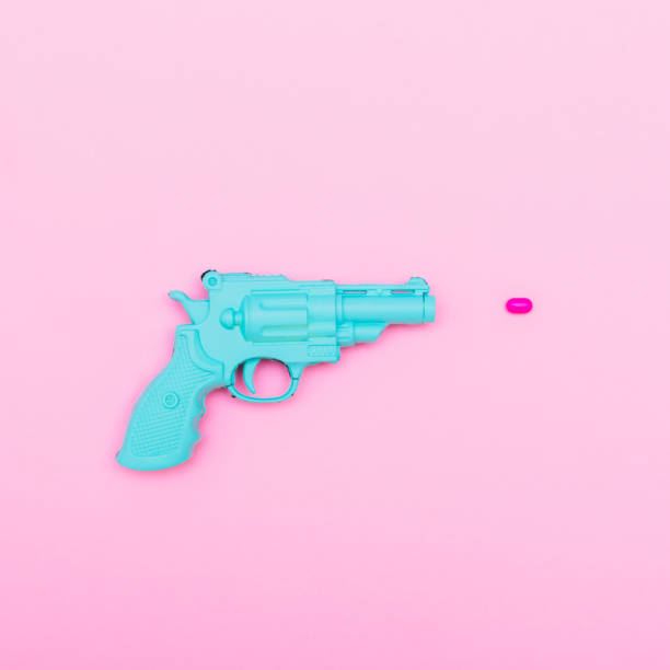 istock plastic gun shoots a pink bullet 921681860