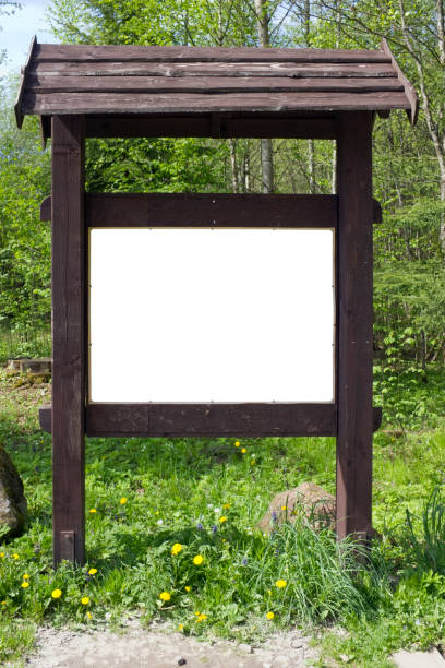 istock On the spring forest  glade there is a aged brown  wooden stand with information. 921684420