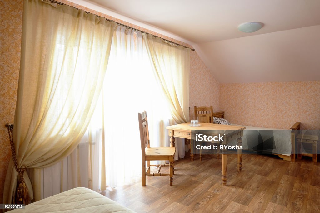 Rural Hostel Room Interior Rural Hostel Room Interior with Wooden Furniture Architectural Cornice Stock Photo