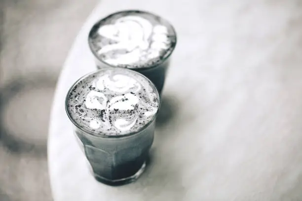 Photo of Two activated charcoal lattes