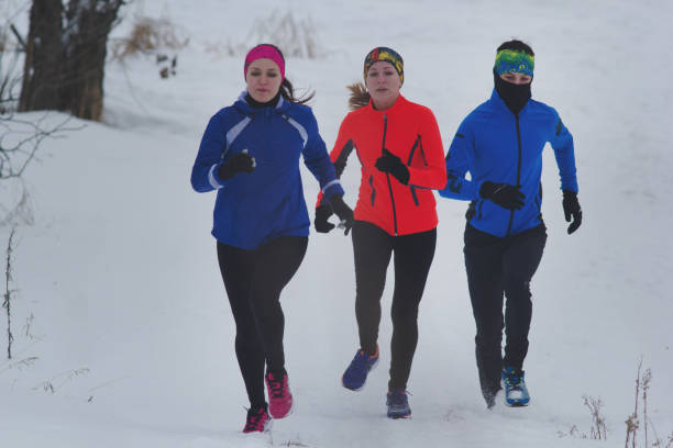 istock Group of young athletes running technically in winter forest 921685556
