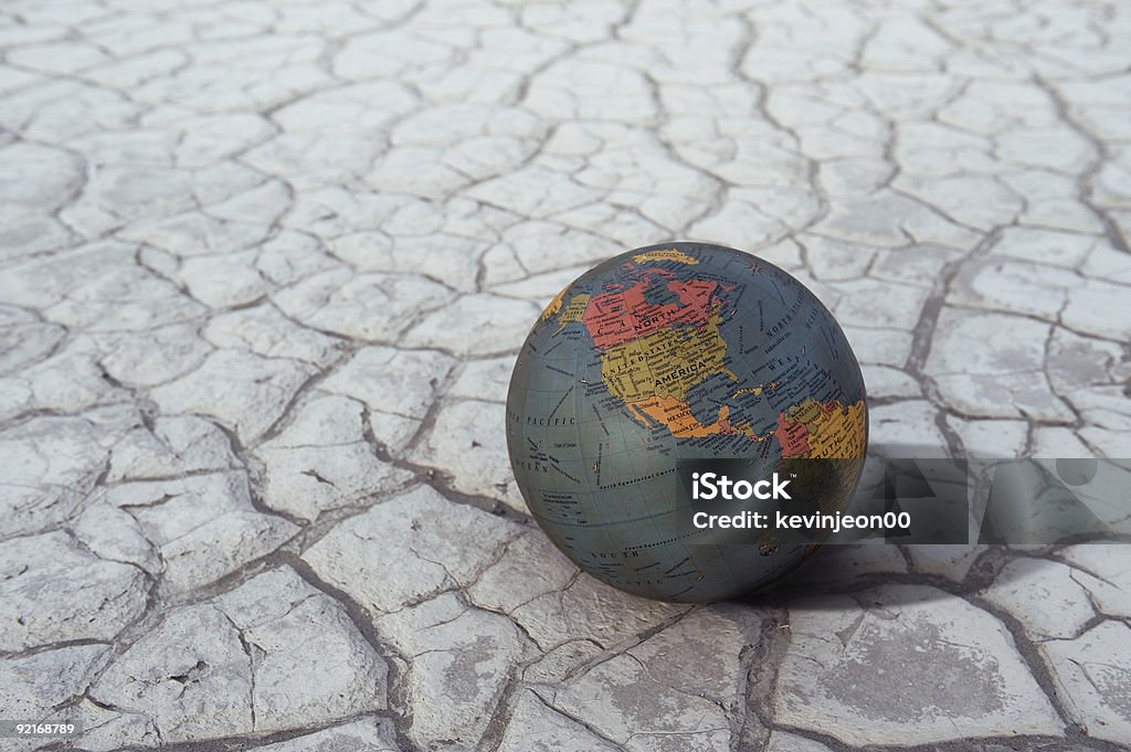 World Globe Because of global warming there is a cracked ground and a globe sits upon it Globe - Navigational Equipment Stock Photo