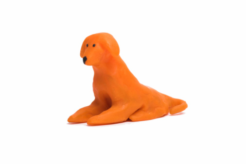 Handmade orange fox figurine of modeling clay.