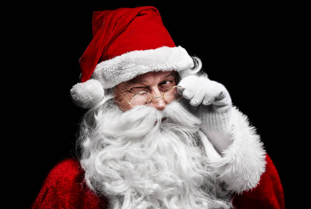 Man in santa claus costume winking stock photo