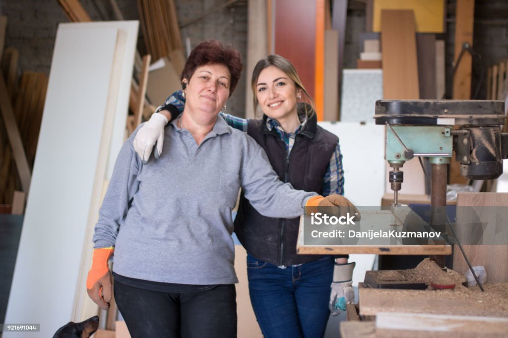 Mother and daughter at woodworking workshop Women, Mother, Only Women, 20-24 Years, 50-54 Years Mother Stock Photo