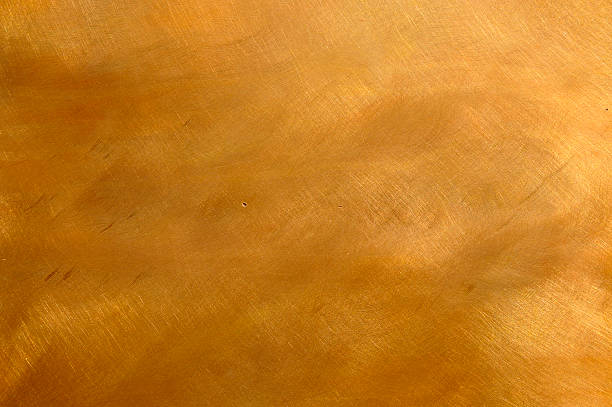 Beautiful copper bronze metal texture cloudy scratchy Abstract brushed brown-golden copper or bronze surface, with visible brush strokes. The sheet metal has an appealing cloudy, mottled texture. Horizontal orientation. The image has been shot outdoors during natural day light, full frame and close up. Ideal for backgrounds. The dimensions of the photo are 3300 x 2192 px bronze colored photos stock pictures, royalty-free photos & images