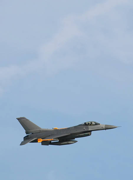 Italian Airforce F-16 Italian Airforce F-16 during a low speed passage with air-to-air missiles on wings and additional tank. sidewinder missile stock pictures, royalty-free photos & images