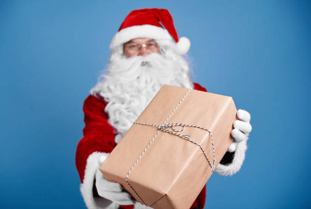 istock Defocused santa claus giving christmas presents 921696776