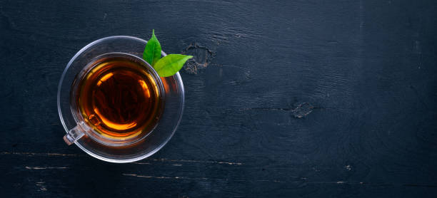 istock A cup of black tea on a wooden background. Top view. Copy space. 921697110