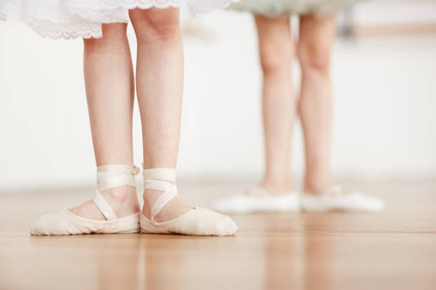 Ballet practice Feet of little ballerina in pointes on the floor during ballet training ballet dancer feet stock pictures, royalty-free photos & images
