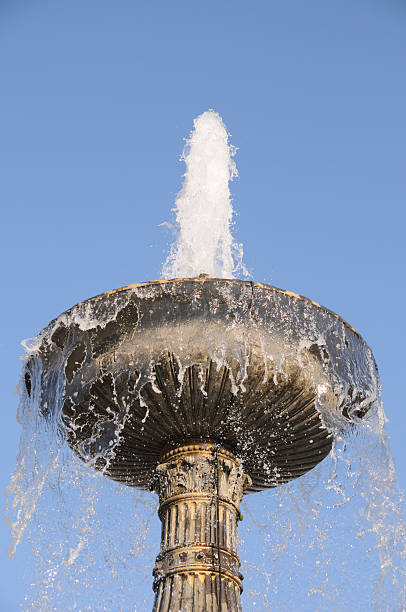 istock Goblet shaped fountain blue sky close up bubbling water 92170489