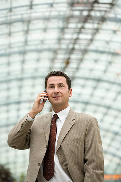 Businessman with cellular, vertical stock photo