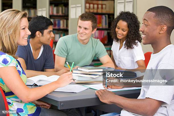 A Group Of College Students Studying At The Library Stock Photo - Download Image Now