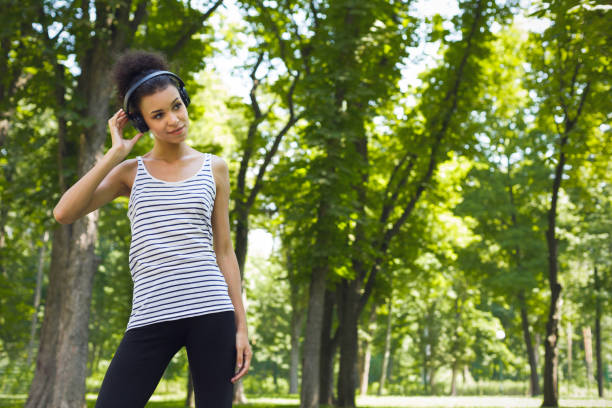 istock African-american woman posing at bright wall 921708604