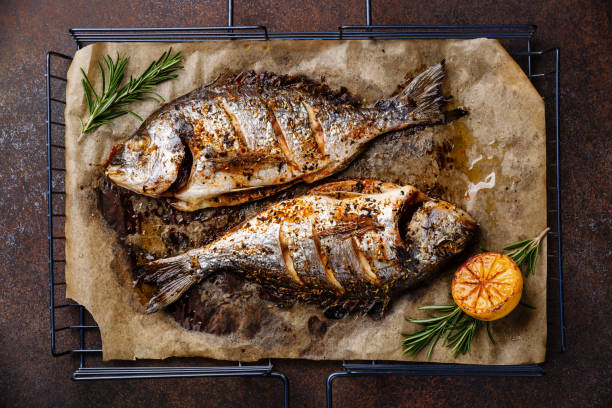 istock Grilled Fish Dorado on grill with lemon and rosemary 921714084