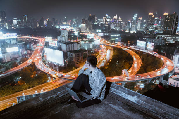 istock Asian businessman using phone and laptop with city  background, technology communication concept 921714100